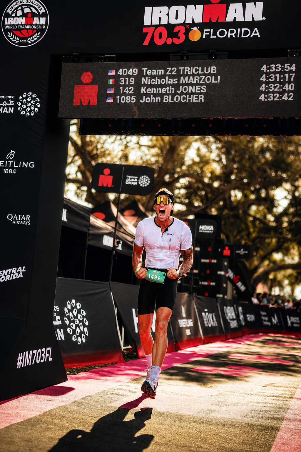 Athlete crossing the Ironman 70.3 finish line